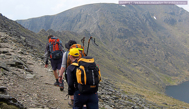 Photograph of three walkers at Striding Edge towards Helvellyn